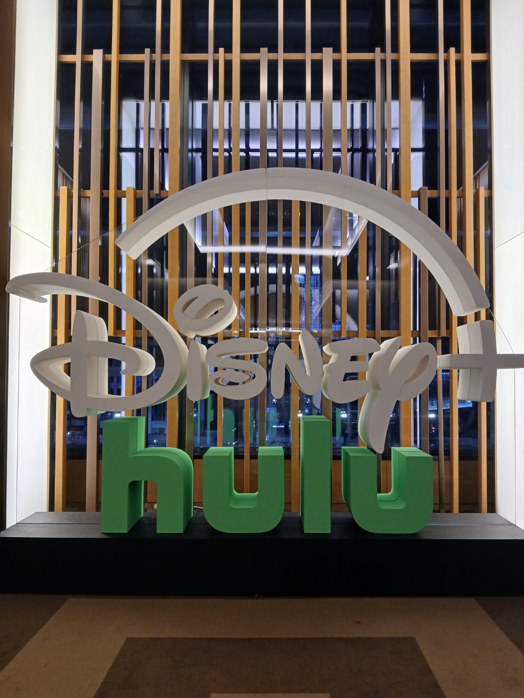 행사 공간에 최종 설치된 Disney+와 Hulu 입체 로고의 세로형 전경